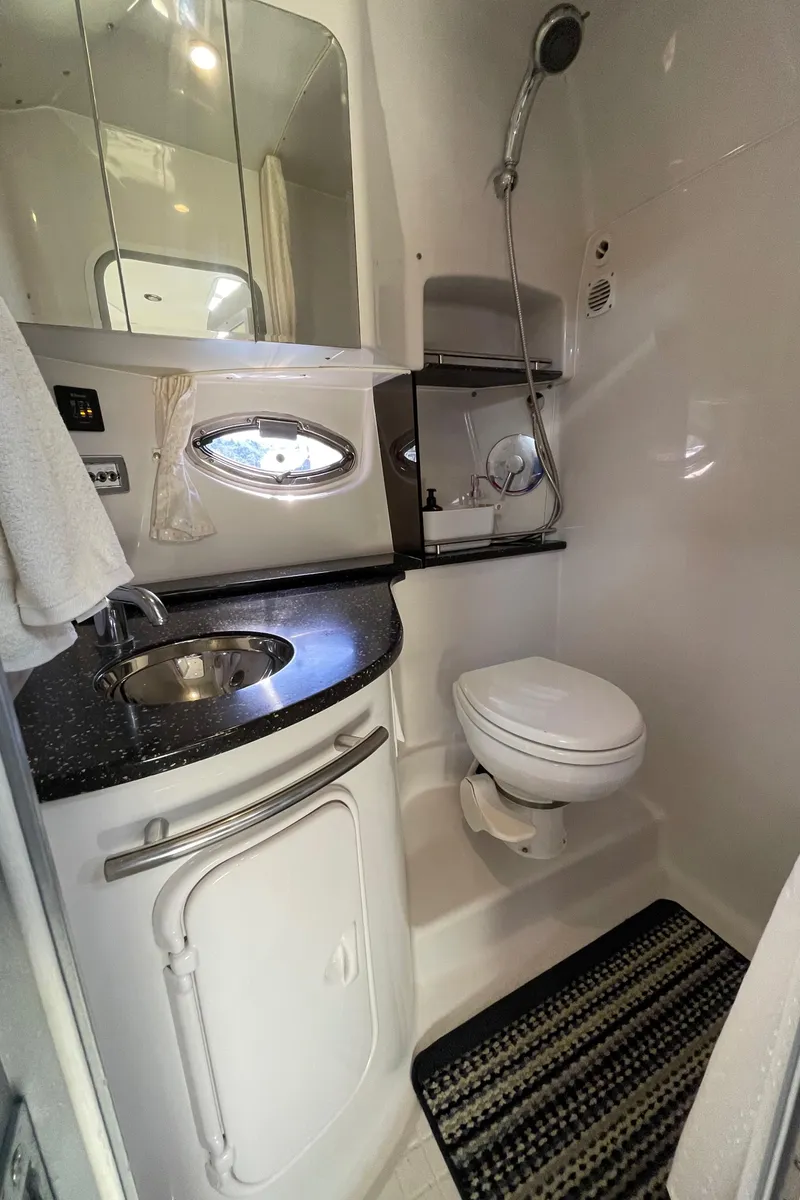Slide: The Image of 2008 Four Winns V338 boat bathroom with sink, toilet, and shower. - 29