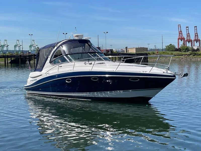 Slide: The Image of 2008 Four Winns V338 boat on calm water with industrial background. - 3