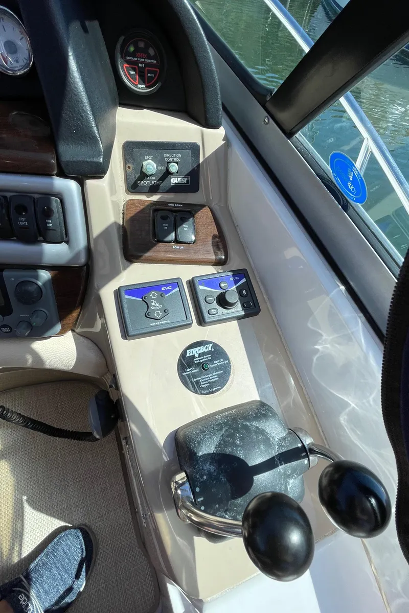 Slide: The Image of Control panel of a 2008 Four Winns V338 boat with throttle and navigation controls. - 35