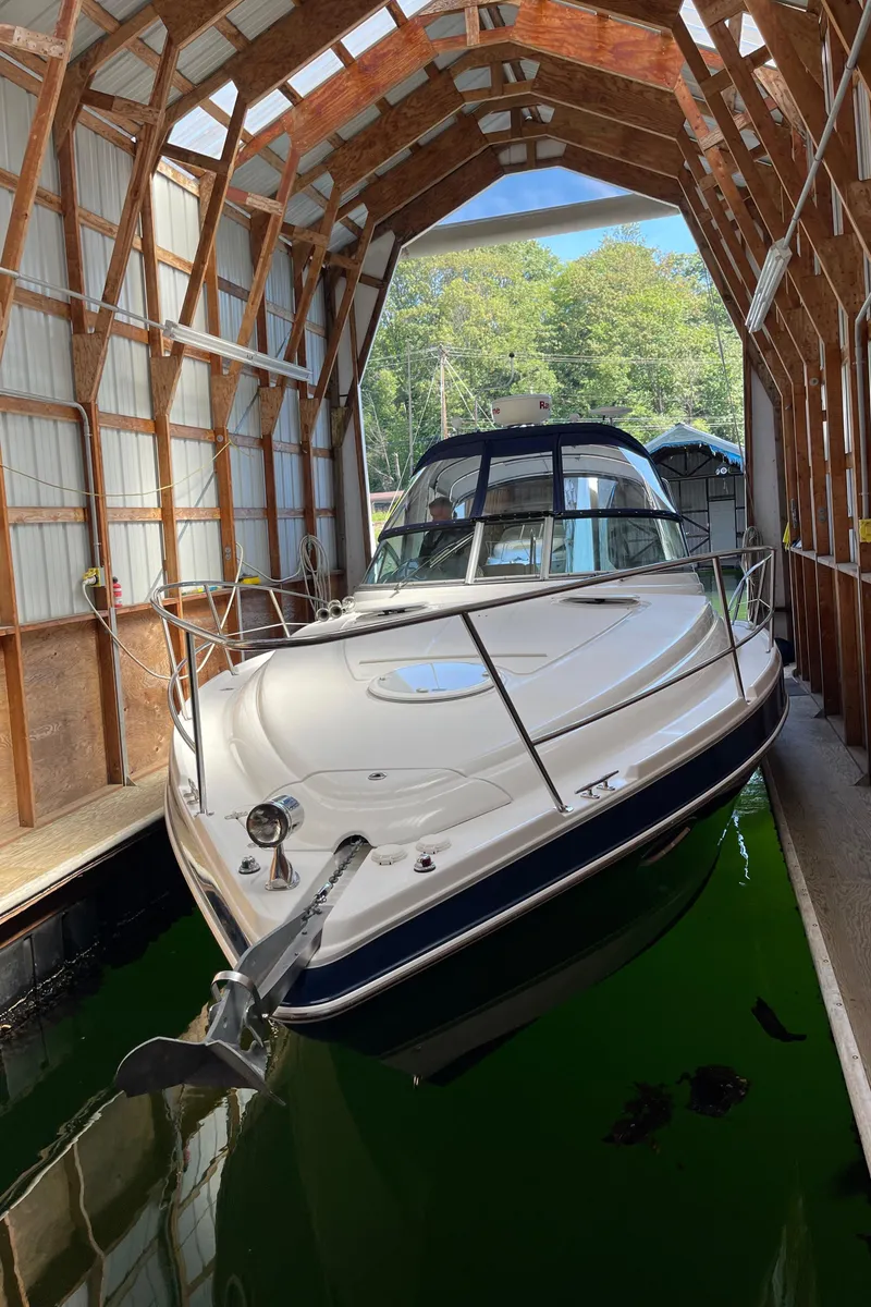 Slide: The Image of 2008 Four Winns V338 boat docked in a covered boathouse. - 42