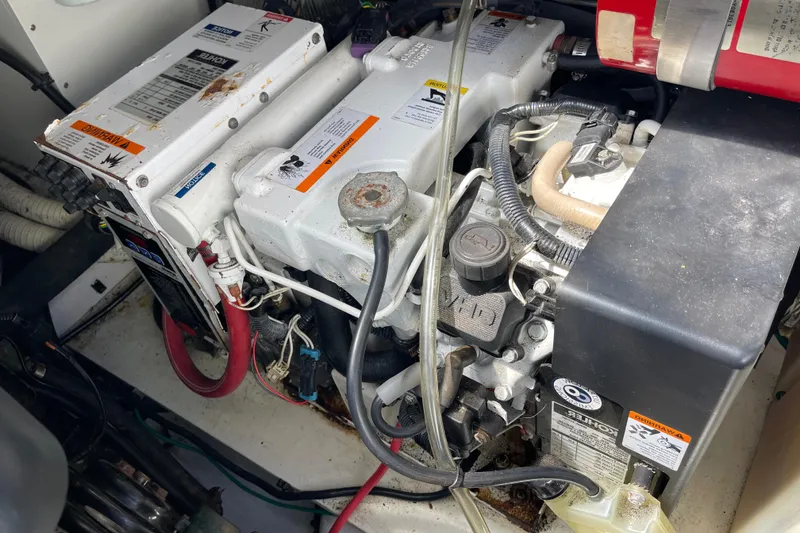 Slide: The Image of 2008 Four Winns V338 engine compartment with visible components and wiring. - 45