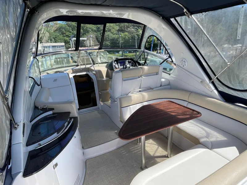 Slide: The Image of 2008 Four Winns V338 boat interior with seating, table, and helm station. - 5