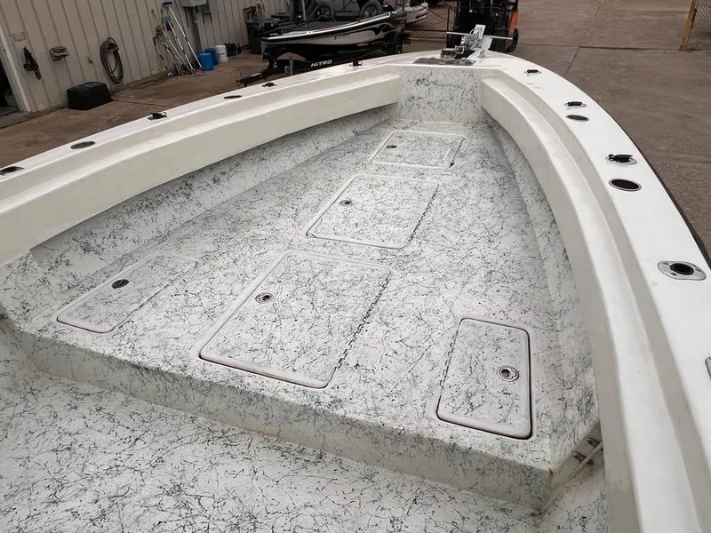 Slide: The Image of 1978 Excalibur 32 boat deck with storage compartments and fishing rod holders. - 14