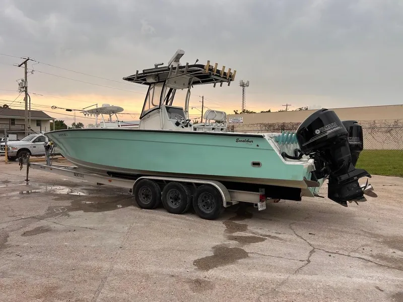 Slide: The Image of 1978 Excalibur 32 boat on a trailer with twin outboard motors. - 3