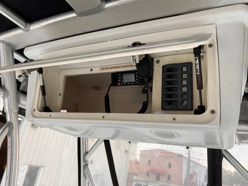 Slide: The Image of 1978 Excalibur 32 boat dashboard with marine radio and control panel. - 32