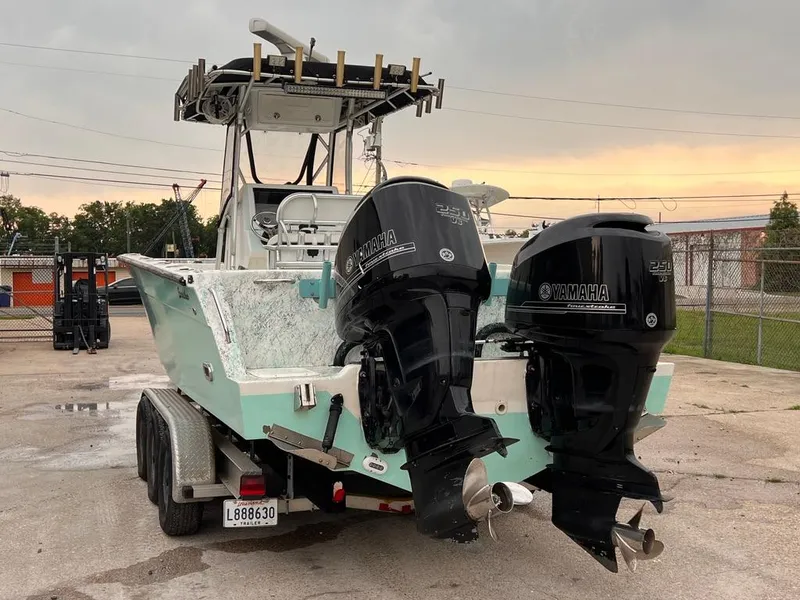 Slide: The Image of 1978 Excalibur 32 boat with dual Yamaha outboard motors on a trailer. - 4