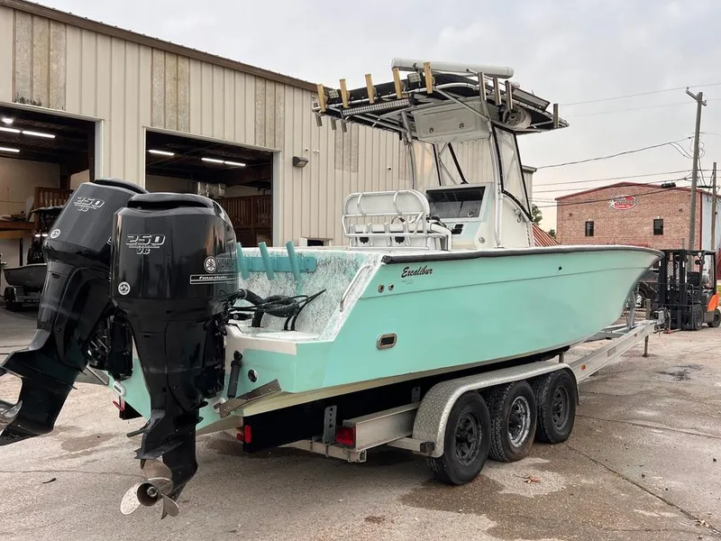 Slide: The Image of 1978 Excalibur 32 boat with twin outboard engines on a trailer. - 5