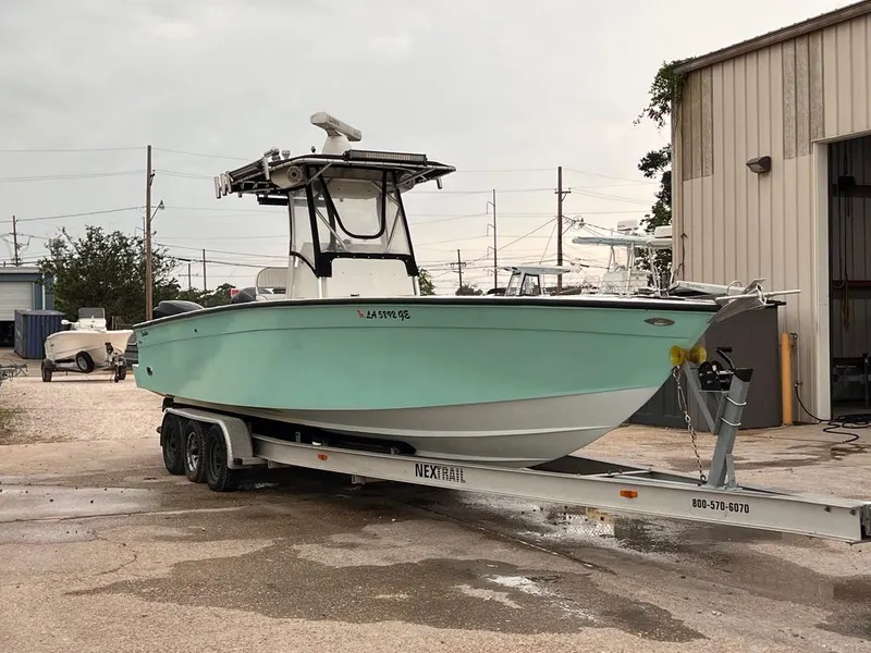 Slide: The Image of 1978 Excalibur 32 boat on a trailer outside a storage facility. - 8
