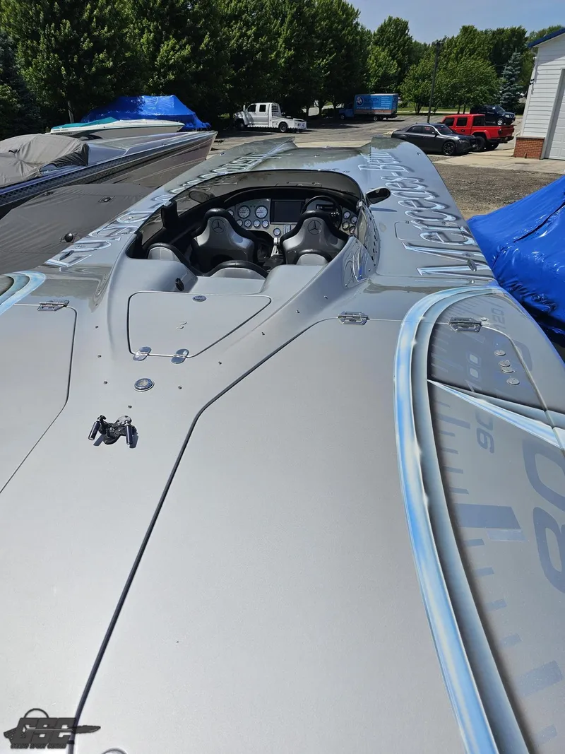 Slide: The Image of 2007 MTI 44 AMG TRIBUTE powerboat with sleek design, docked outdoors. - 18