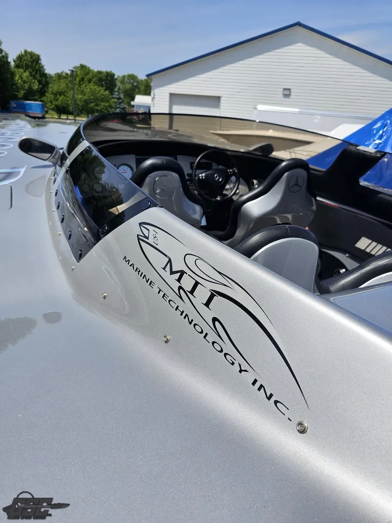 Slide: The Image of 2007 MTI 44 AMG TRIBUTE speedboat cockpit with logo, silver exterior, and modern design. - 27