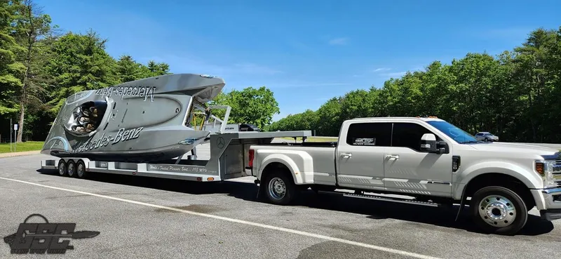 Slide: The Image of 2007 MTI 44 AMG TRIBUTE boat on trailer towed by a white truck. - 3