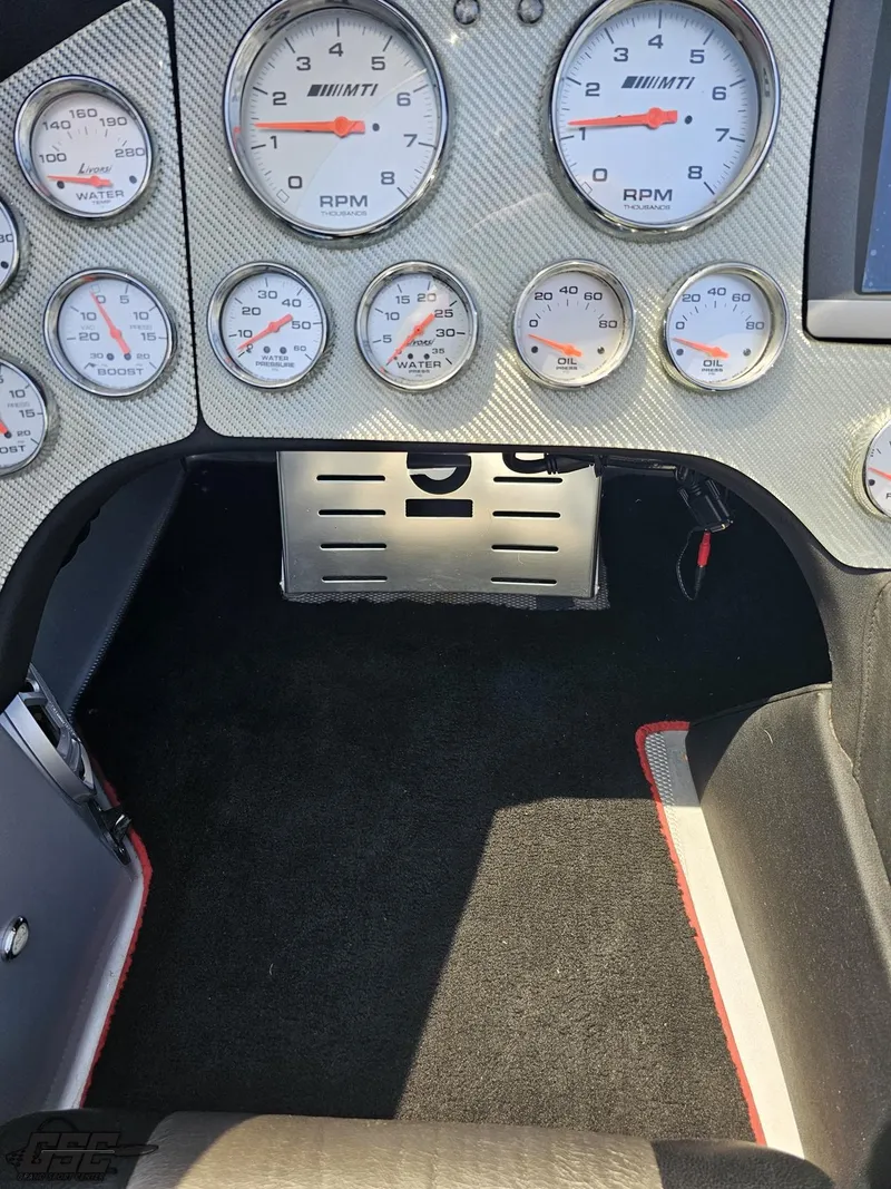 Slide: The Image of 2007 MTI 44 AMG TRIBUTE dashboard with multiple gauges and carbon fiber finish. - 33