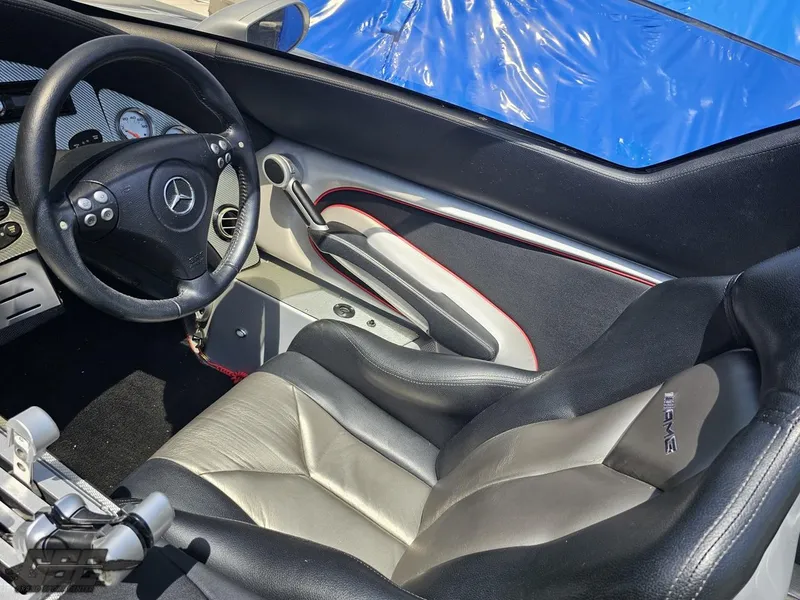 Slide: The Image of Interior of a 2007 MTI 44 AMG TRIBUTE boat with AMG-branded seat and steering wheel. - 36