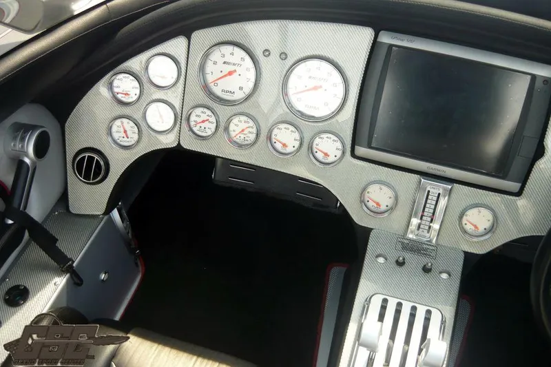 Slide: The Image of Dashboard of a 2007 MTI 44 AMG TRIBUTE boat with gauges and a display screen. - 42
