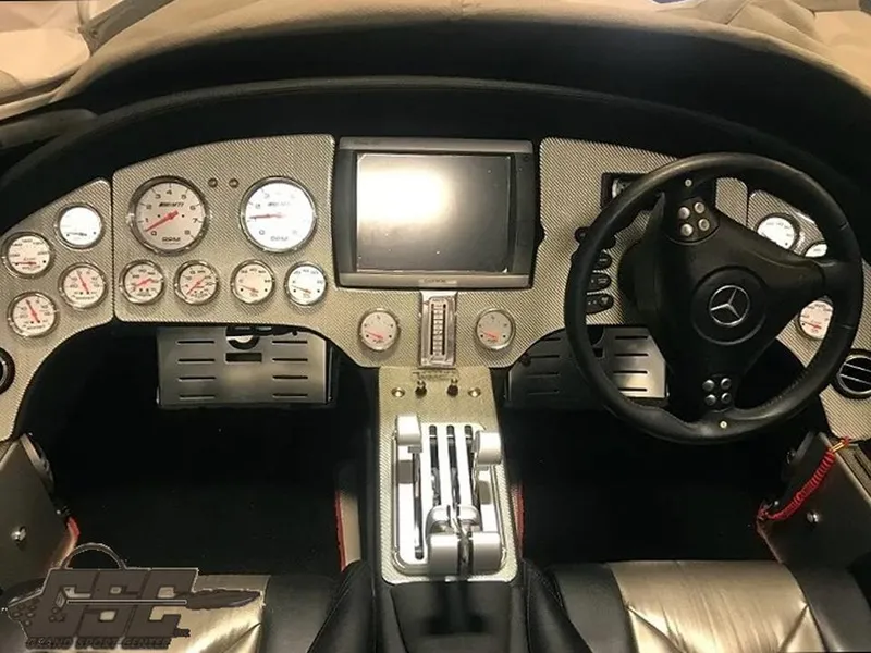 Slide: The Image of 2007 MTI 44 AMG TRIBUTE dashboard with gauges, steering wheel, and control panel. - 44