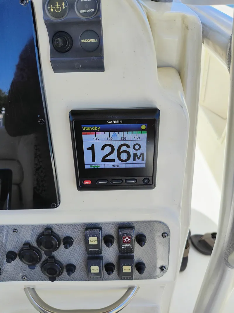 Slide: The Image of 2008 Hydra-Sports Vector 2900 CC boat dashboard with Garmin display and control switches. - 49