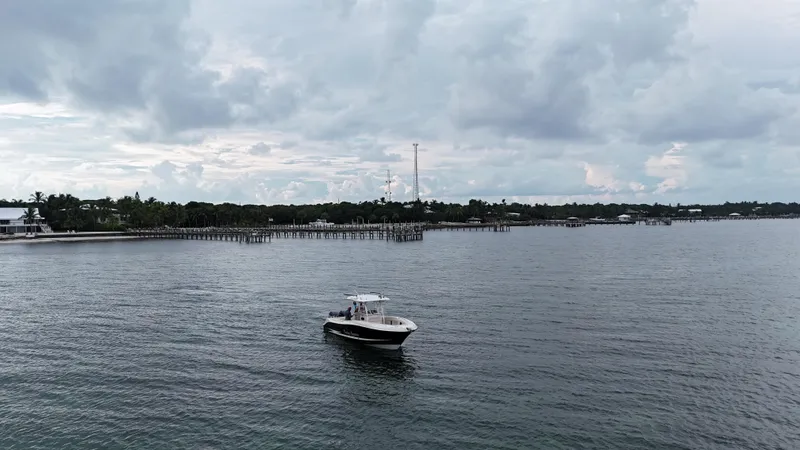 Slide: The Image of 2008 Hydra-Sports Vector 2900 CC boat on calm waters near a coastal pier. - 6