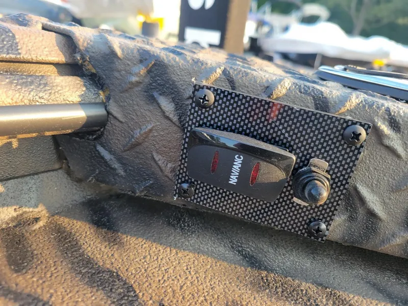 Slide: The Image of Control panel on Xpress XTS16 duck hunting boat, featuring navigation switch, textured surface. - 12