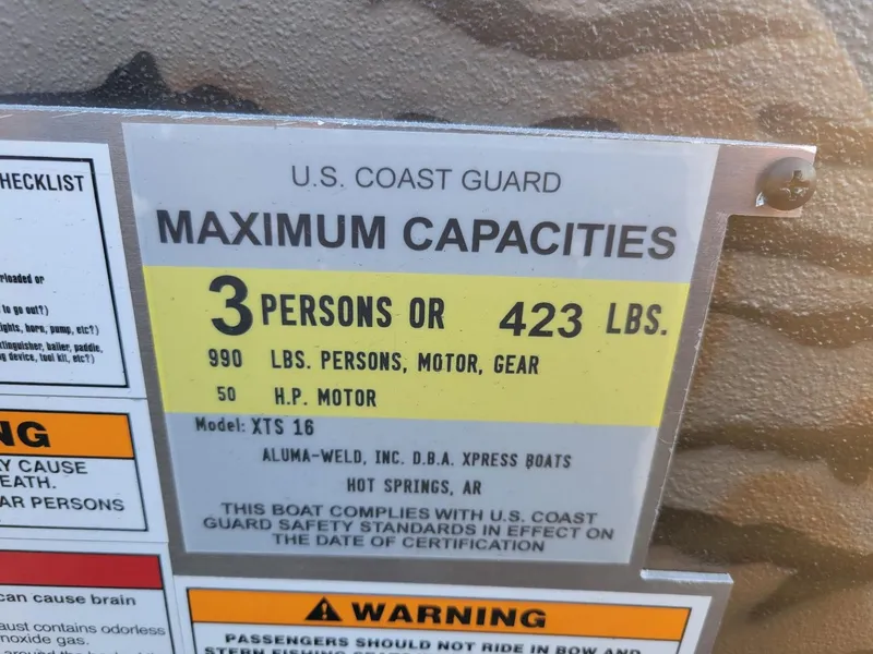Slide: The Image of U.S. Coast Guard capacity label on Xpress XTS16 duck hunting boat, 3 persons or 423 lbs. - 6