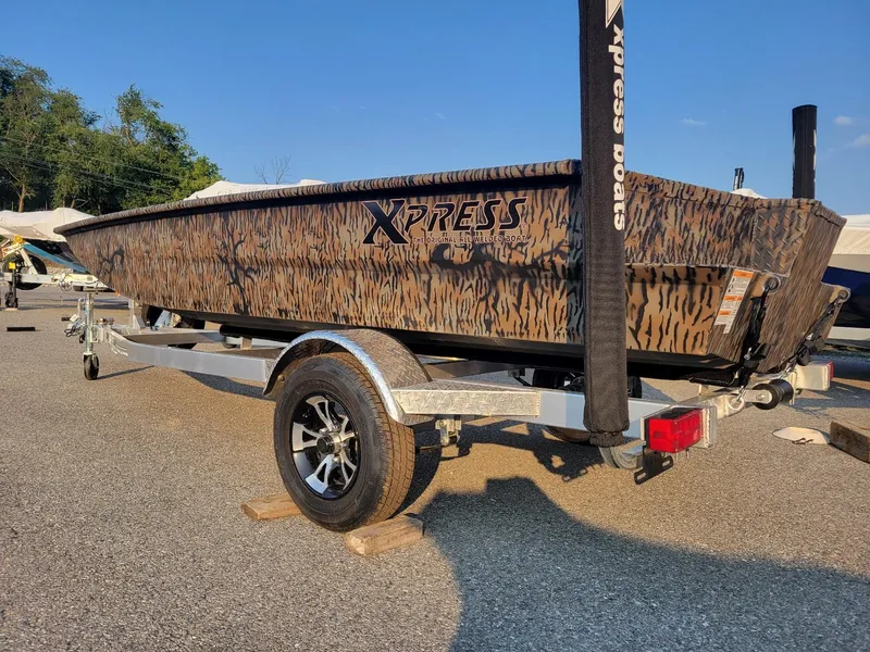Slide: The Image of 2025 Xpress XTS16 duck hunting boat with Yamaha 25 hp engine on trailer. - 6