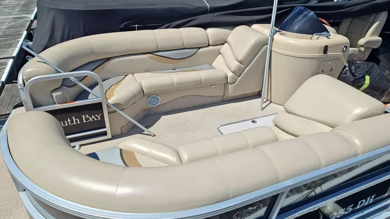 Slide: The Image of 2011 South Bay 722CR pontoon boat with beige seating and spacious layout. - 11