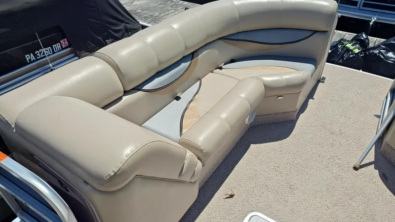 Slide: The Image of 2011 South Bay 722CR pontoon boat with beige seating and carpeted deck. - 13