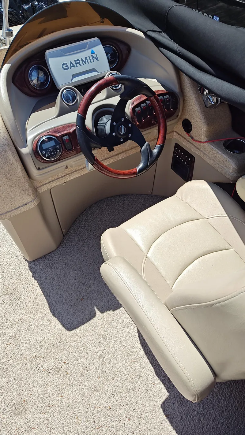 Slide: The Image of 2011 South Bay 722CR boat dashboard with Garmin navigation system and leather captain's chair. - 14