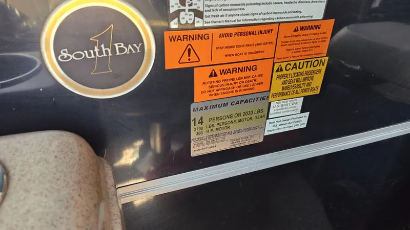 Slide: The Image of 2011 South Bay 722CR boat capacity and safety warning labels. - 3