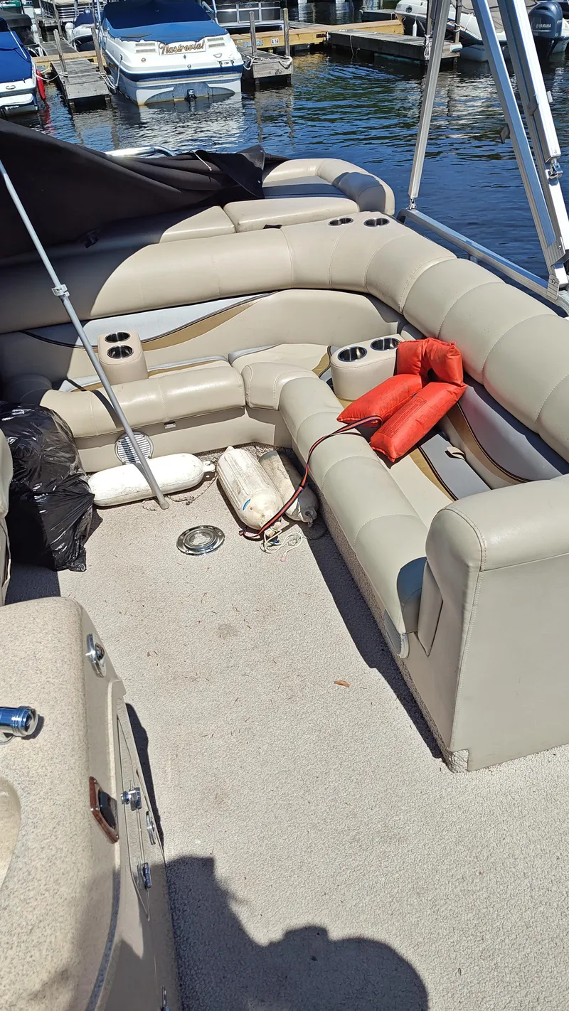 Slide: The Image of Interior of a 2011 South Bay 722CR pontoon boat with beige seating and life jackets. - 5