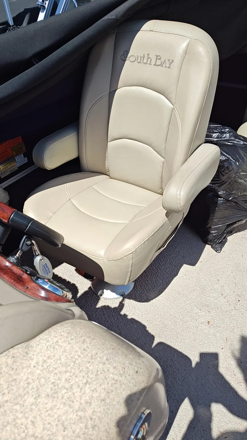 Slide: The Image of Captain's chair of a 2011 South Bay 722CR pontoon boat. - 6