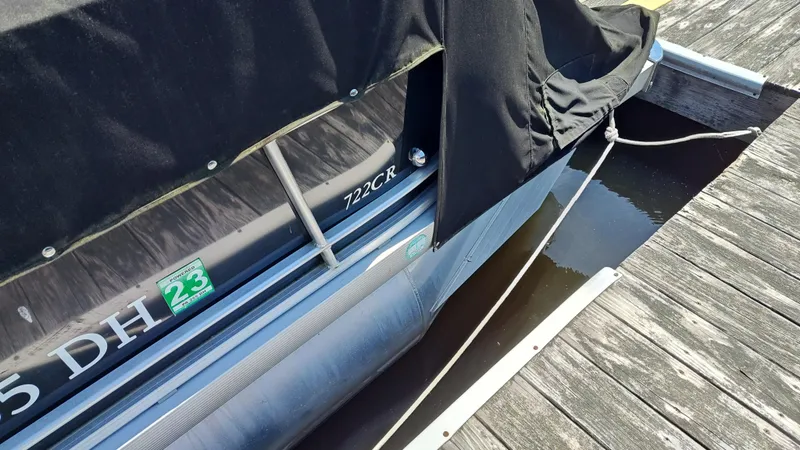 Slide: The Image of 2011 South Bay 722CR pontoon boat docked with cover. - 9