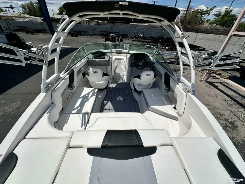 Slide: The Image of 2022 Chaparral 23 Surf boat interior with seating and steering console. - 13