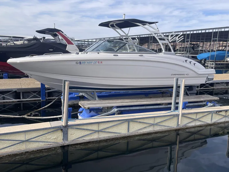Slide: The Image of 2022 Chaparral 23 Surf boat docked at marina, side view. - 15