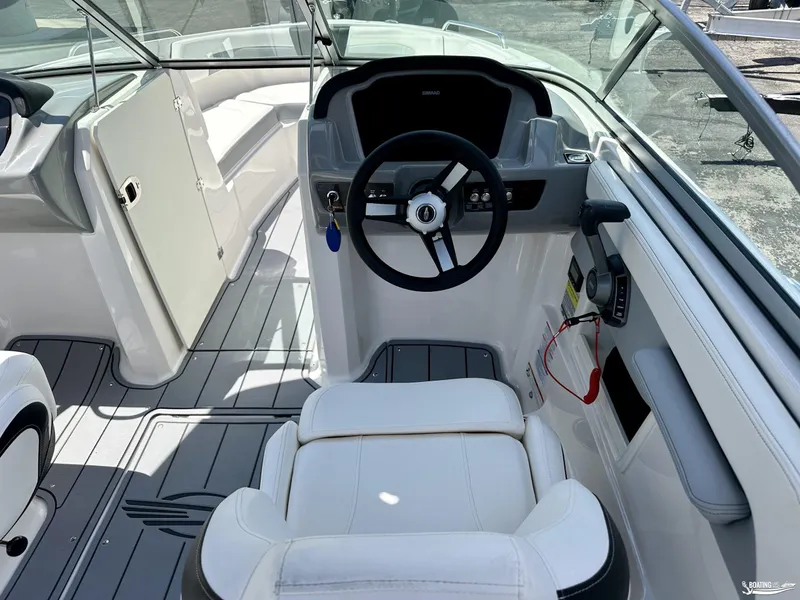 Slide: The Image of 2022 Chaparral 23 Surf boat interior with steering wheel and seating. - 19