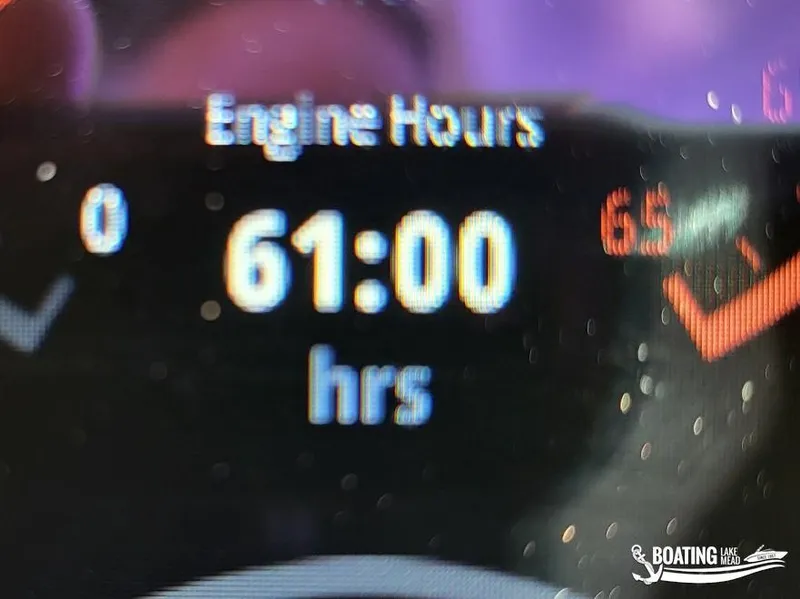 Slide: The Image of Chaparral 23 Surf 2022 engine hours display showing 61 hours. - 25