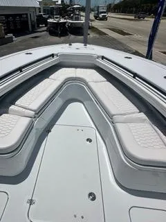 Slide: The Image of 2024 Yellowfin 32CC OFFSHORE boat with white cushioned seating and spacious deck. - 10