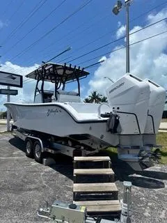 Slide: The Image of 2024 Yellowfin 32CC Offshore boat on trailer with twin outboard engines. - 2