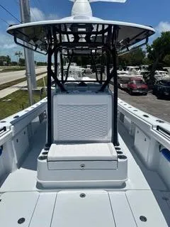 Slide: The Image of 2024 Yellowfin 32CC OFFSHORE boat with center console and seating, docked under clear skies. - 8