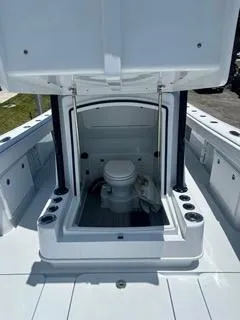 Slide: The Image of 2024 Yellowfin 32CC Offshore boat with open console showing marine toilet. - 9