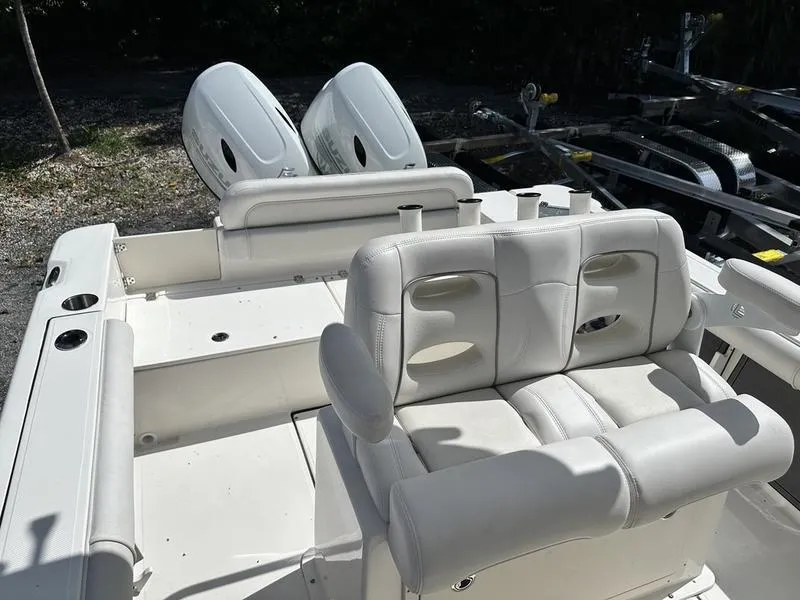 Slide: The Image of 2023 Sea Born FX24 Bay LE boat interior with dual engines and white seating. - 4