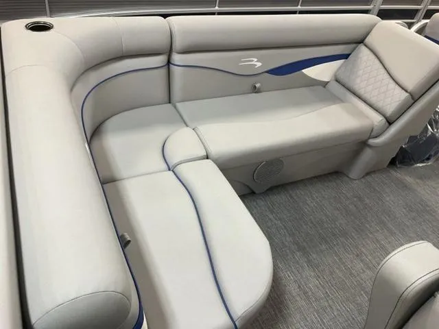 Slide: The Image of 2025 Bennington 188 SVL boat interior with gray seating and blue accents. - 13