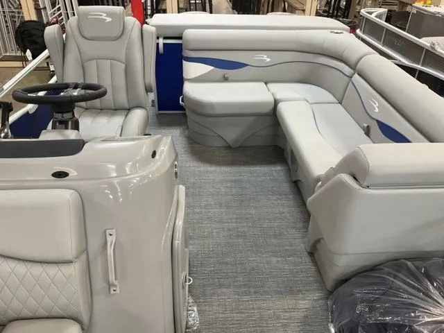 Slide: The Image of 2025 Bennington 188 SVL pontoon boat interior with gray seating and steering console. - 16