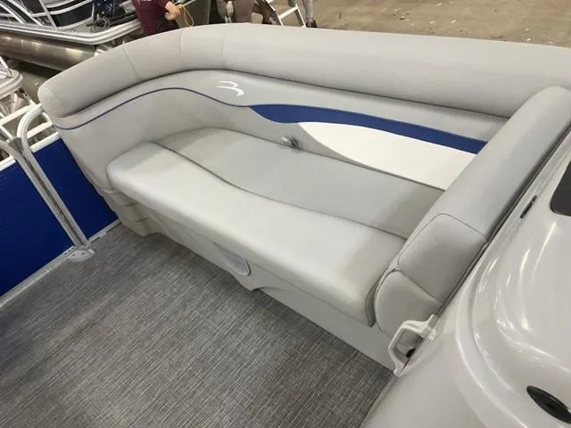 Slide: The Image of 2025 Bennington 188 SVL boat interior with gray and blue cushioned seating. - 18