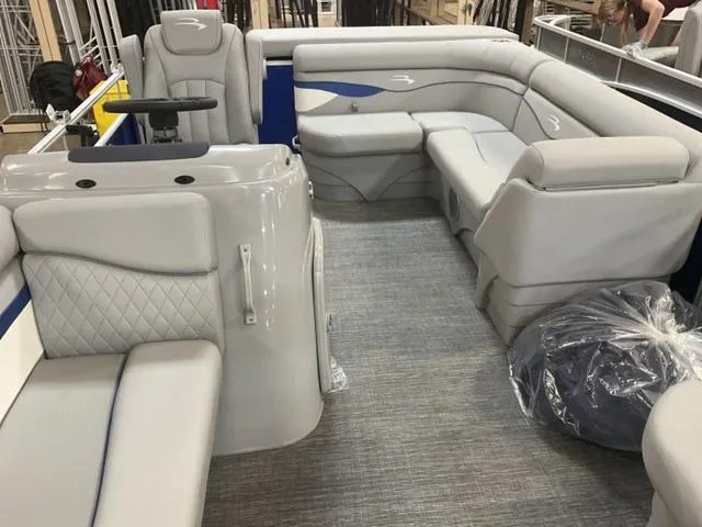 Slide: The Image of 2025 Bennington 188 SVL pontoon boat interior with plush gray seating and modern design. - 19