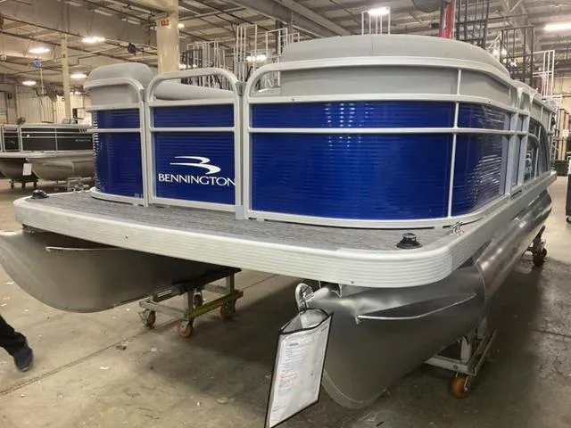 Slide: The Image of 2025 Bennington 188 SVL pontoon boat in a warehouse setting. - 3