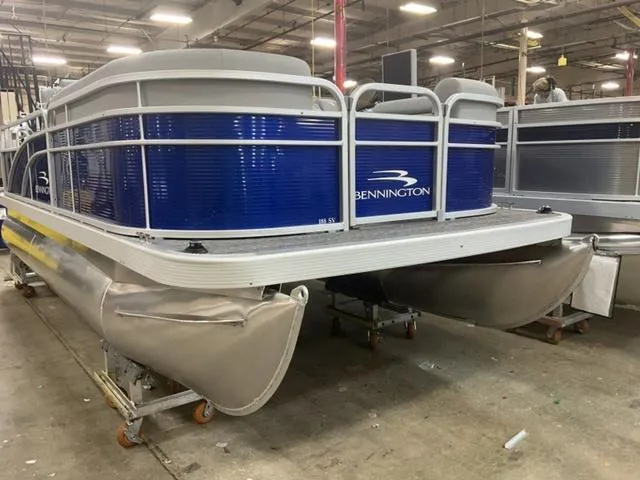 Slide: The Image of 2025 Bennington 188 SVL pontoon boat in a warehouse setting. - 4