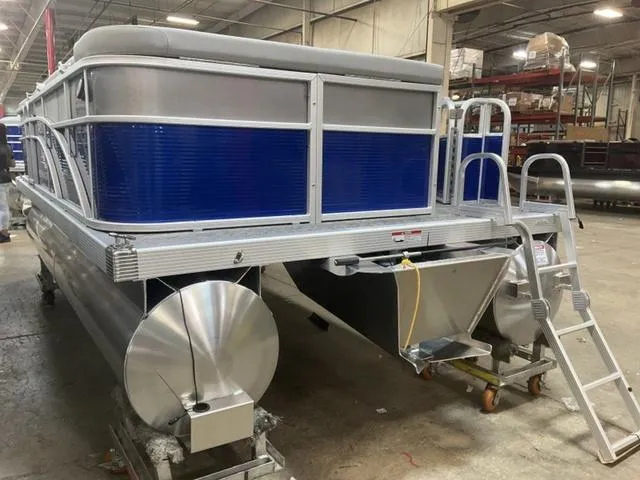 Slide: The Image of 2025 Bennington 188 SVL pontoon boat in warehouse, blue and silver design. - 8