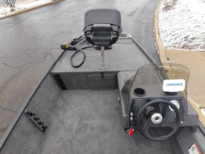 Slide: The Image of 2024 Tracker Bass Tracker Classic XL boat interior with steering wheel and Lowrance fish finder. - 3