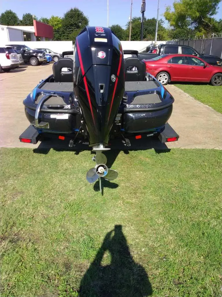 Slide: The Image of 2024 Nitro Z19 boat with powerful outboard motor, parked on grass. - 4