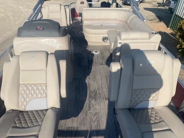 Slide: The Image of 2024 Ranger Reata 220F boat interior with beige seating and wood-style flooring. - 3